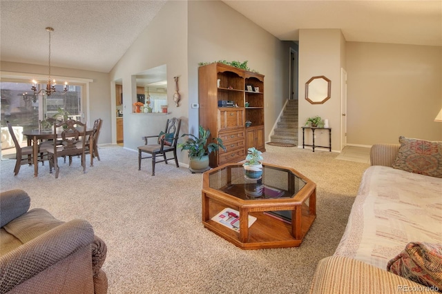 living room featuring a notable chandelier, vaulted ceiling, a textured ceiling, and carpet