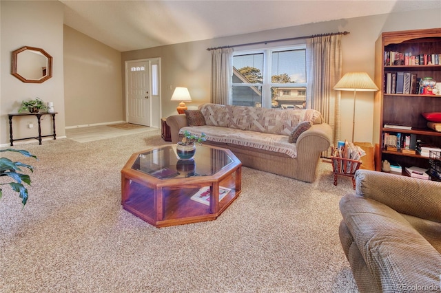 living room with lofted ceiling and carpet floors