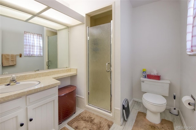 bathroom featuring vanity, toilet, and walk in shower