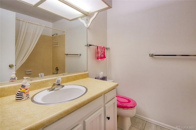 bathroom with vanity, tile patterned flooring, and toilet