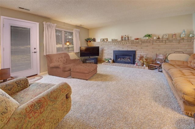 living room with carpet flooring, a fireplace, and a textured ceiling