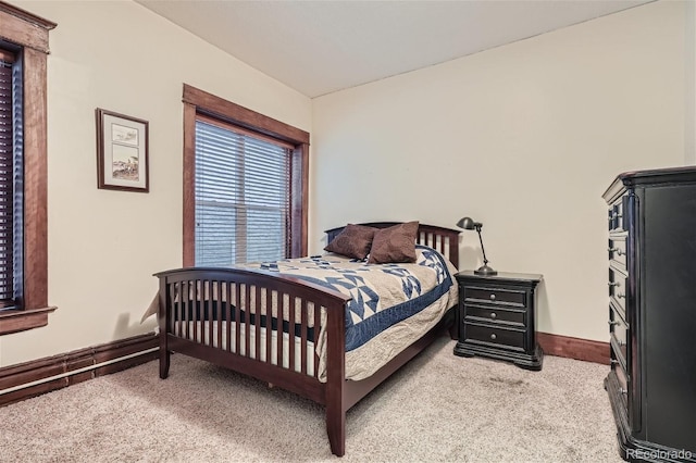 bedroom featuring baseboards and light colored carpet