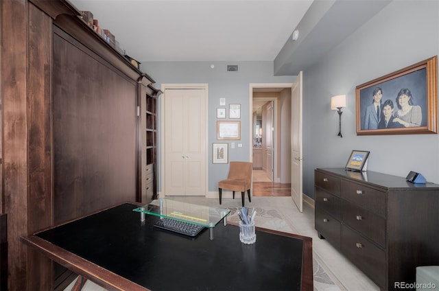 office area featuring light tile patterned floors and a barn door