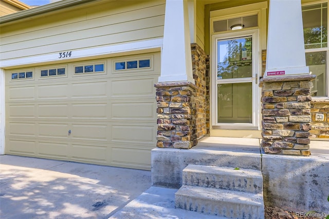 3514 E 141st Dr, Thornton, CO 80602 - entrance to property featuring stone siding, a garage, and driveway
