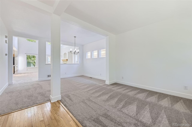 3514 E 141st Dr, Thornton, CO 80602 - empty room with carpet floors, a chandelier, and wood-type flooring