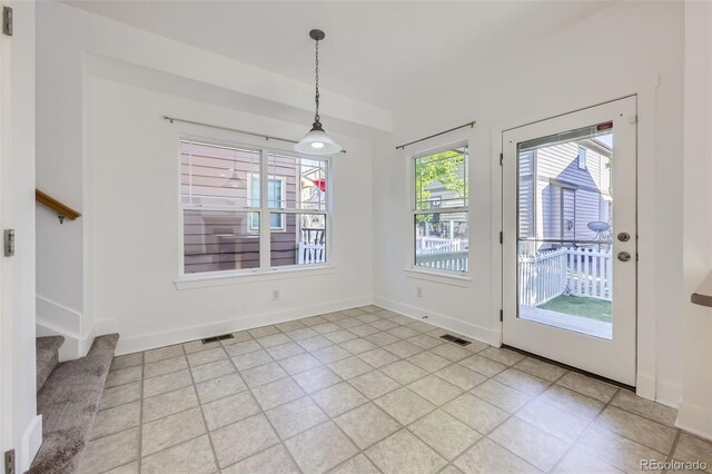 3514 E 141st Dr, Thornton, CO 80602 - unfurnished dining area with stairway and light tile patterned floors
