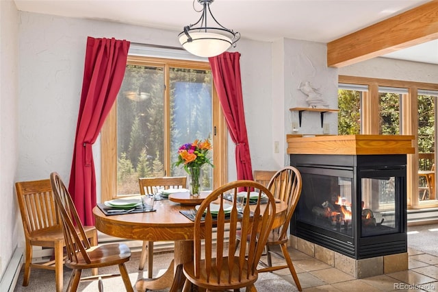 805 Columbine Rd Unit 202, Breckenridge, CO 80424 - tiled dining room featuring a multi sided fireplace and beam ceiling