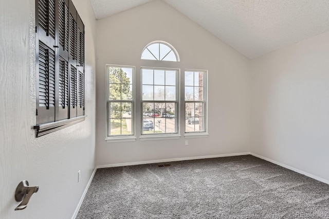 unfurnished room featuring carpet, vaulted ceiling, and baseboards