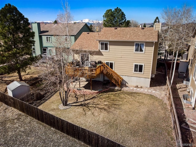 back of property featuring a wooden deck and fence