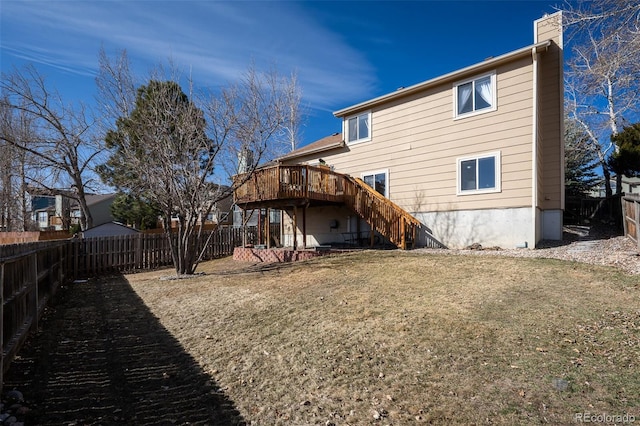 rear view of house with a lawn, a deck, a fenced backyard, stairs, and a chimney