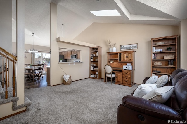 living area with vaulted ceiling with skylight, a chandelier, light colored carpet, and baseboards