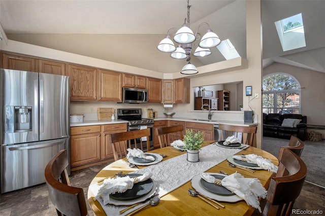 dining area featuring an inviting chandelier and vaulted ceiling with skylight