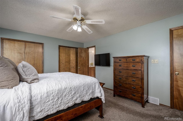 bedroom featuring carpet flooring, baseboards, visible vents, and a textured ceiling