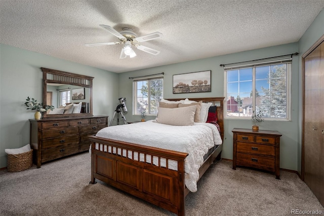 carpeted bedroom with baseboards, a textured ceiling, and ceiling fan