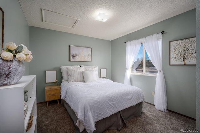 carpeted bedroom with a textured ceiling, attic access, and baseboards