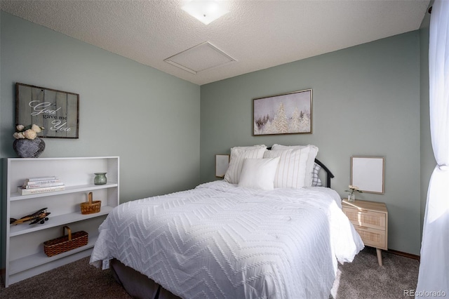 bedroom with carpet floors, a textured ceiling, and attic access