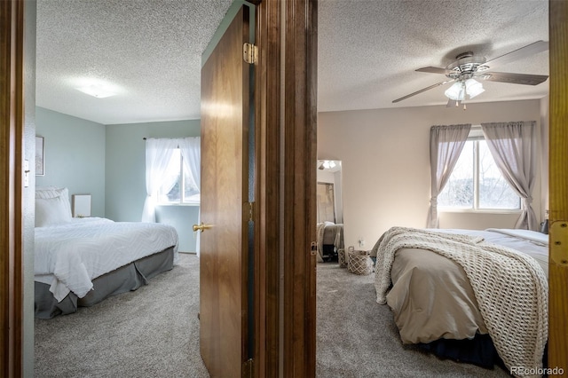 bedroom with a textured ceiling, a ceiling fan, and carpet floors