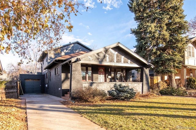 view of front facade featuring a garage, covered porch, and a front lawn