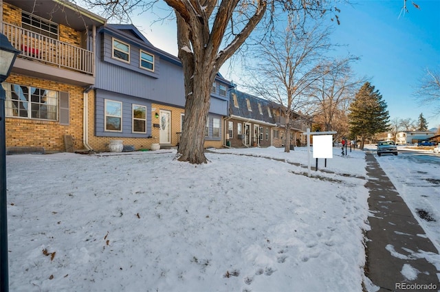 view of snow covered rear of property