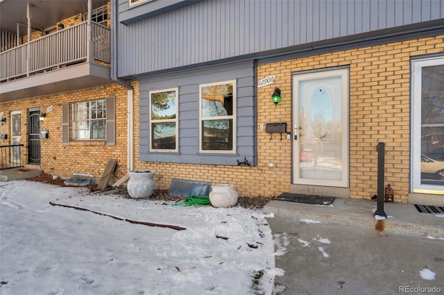 view of snow covered property entrance