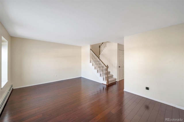 spare room with dark hardwood / wood-style floors and baseboard heating