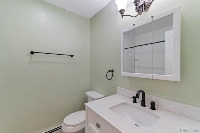 bathroom featuring vanity, toilet, and a baseboard heating unit