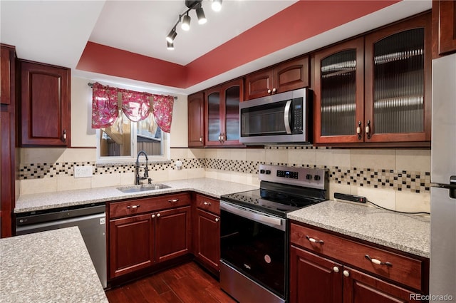 kitchen featuring dark hardwood / wood-style flooring, sink, backsplash, and stainless steel appliances