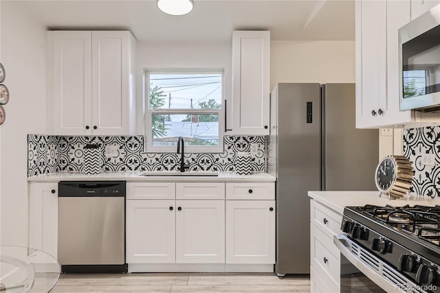 4435-4455 Elizabeth, Denver, CO 80206 - kitchen featuring appliances with stainless steel finishes, light countertops, and white cabinets