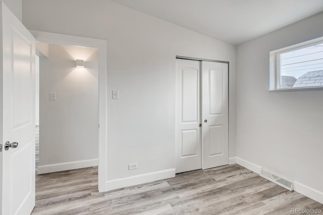 4435-4455 Elizabeth, Denver, CO 80206 - unfurnished bedroom with light wood-style floors and a closet