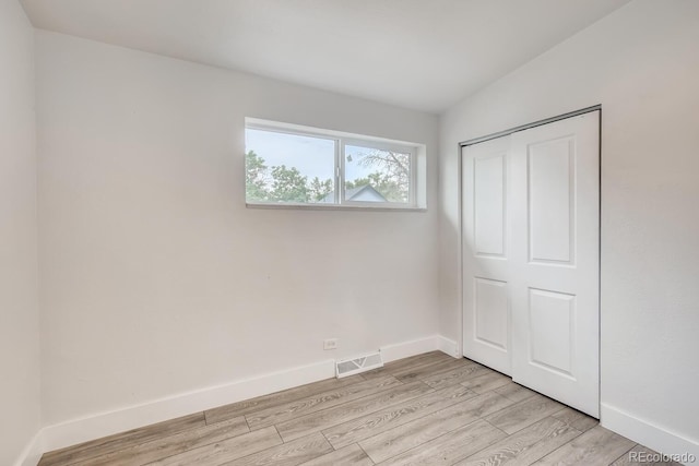 4435-4455 Elizabeth, Denver, CO 80206 - unfurnished bedroom featuring light wood finished floors and a closet