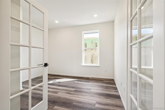 unfurnished room featuring dark wood-style floors, recessed lighting, baseboards, and french doors