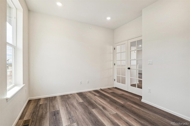 spare room with dark wood-style floors, french doors, recessed lighting, and baseboards