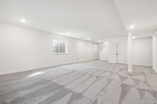 basement featuring recessed lighting, light colored carpet, stairway, and baseboards