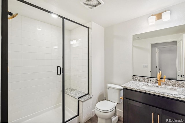 full bathroom with toilet, wood finished floors, vanity, visible vents, and a stall shower