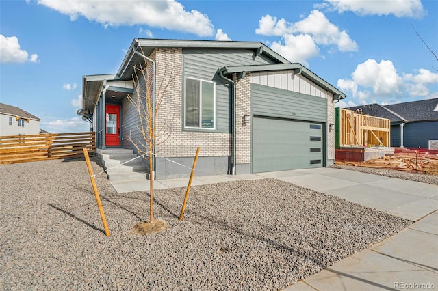 ranch-style house featuring driveway, an attached garage, fence, board and batten siding, and brick siding