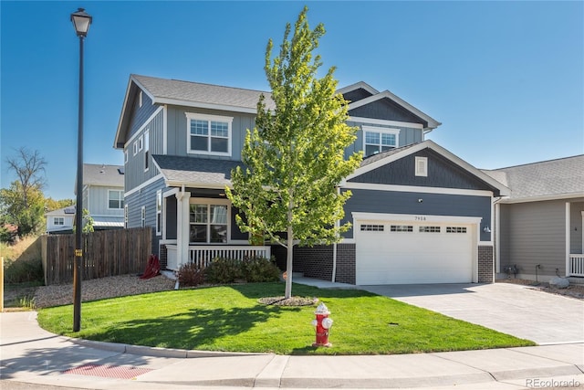 craftsman house with fence, a front lawn, an attached garage, driveway, and a porch