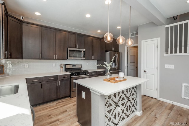7958 Tejon St, Denver, CO 80221 - kitchen featuring appliances with stainless steel finishes, light wood-style flooring, dark brown cabinetry, decorative backsplash, and recessed lighting