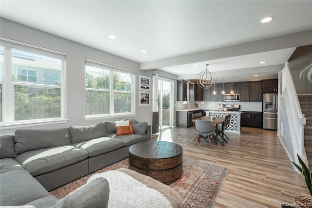 7958 Tejon St, Denver, CO 80221 - living room featuring a chandelier, light wood-type flooring, recessed lighting, and stairway