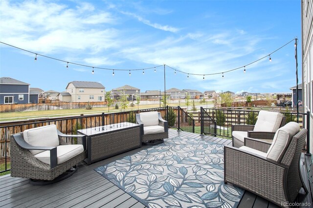 deck featuring fence and a residential view