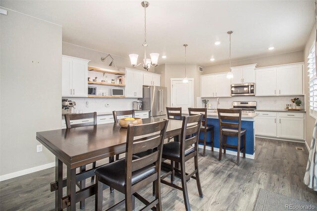 dining area featuring visible vents, an inviting chandelier, baseboards, dark wood-type flooring, and recessed lighting