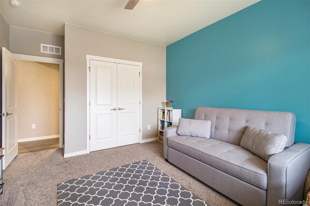 living area featuring carpet floors, baseboards, and visible vents