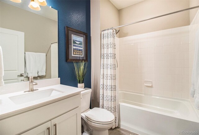 bathroom with toilet, tile patterned floors, shower / bath combo, and vanity