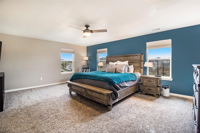bedroom featuring visible vents, carpet flooring, baseboards, and a ceiling fan