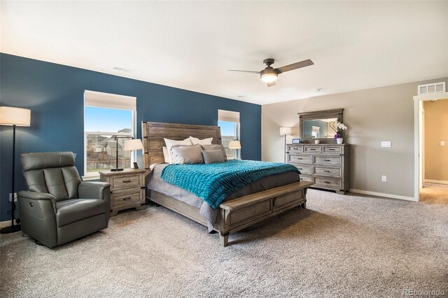 bedroom featuring light colored carpet, visible vents, and multiple windows