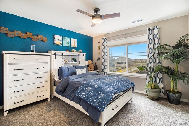 bedroom featuring baseboards, a ceiling fan, dark carpet, and visible vents