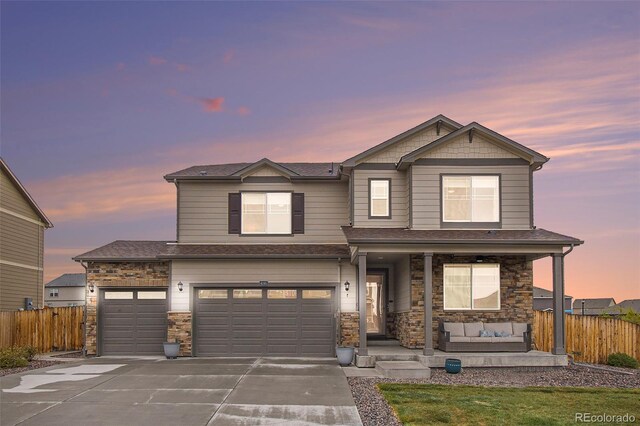 8395 E 132nd Pl, Thornton, CO 80602 - view of front facade with a porch, fence, driveway, and stone siding
