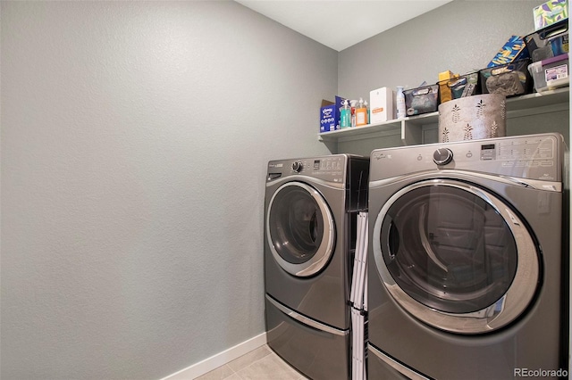 8395 E 132nd Pl, Thornton, CO 80602 - laundry area featuring washer and clothes dryer, light tile patterned floors, and baseboards