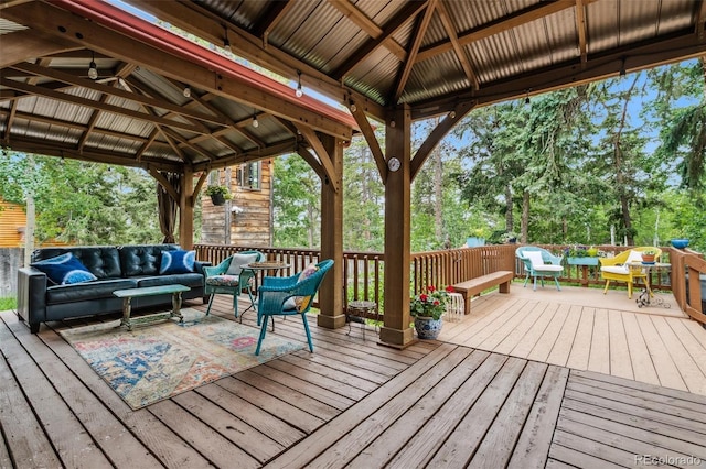 10990 Oehlman Ave, Conifer, CO 80433 - wooden terrace with a gazebo, outdoor lounge area, and view of scattered trees