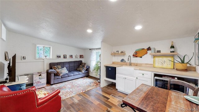 10990 Oehlman Ave, Conifer, CO 80433 - living area featuring wood finished floors, lofted ceiling, a textured ceiling, and recessed lighting