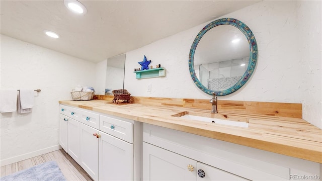 10990 Oehlman Ave, Conifer, CO 80433 - bathroom with vanity, wood finished floors, and recessed lighting